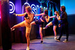 © ADDICTIVE STOCK - Women practicing kickboxing in a fitness studio training session