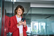 © Stock 4 You - Mature European business woman manager ceo using cell phone mobile app. Smiling Latin Hispanic middle-aged female businesswoman holding smartphone in office reading trading, working online. Copy space