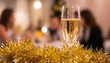 © Aleksei - A glass of sparkling wine against a festive background of tinsel at a party with a blurred background