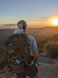 © Alba Vitta Studio/Stocksy - Backpacker with Cat on Mountain Peak
