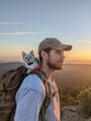 © Alba Vitta Studio/Stocksy - Backpacker with Cat on Mountain Peak