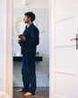 © OchreOchre/Stocksy - Man in Casual Clothing Standing in the Bathroom Early Morning