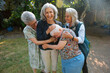 © Rob and Julia Campbell/Stocksy - Happy seniors hug and share joyful moment in garden