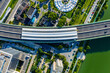© Yic Ma/Stocksy - Aerial view of city overpass with solar panels and green surroundings