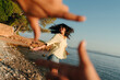 © Lucas Ottone/Stocksy - Young woman dancing at the beach portrait