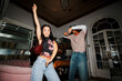 © BONNINSTUDIO/Stocksy - Young people dancing having fun at house party