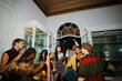 © BONNINSTUDIO/Stocksy - Diverse young adults enjoying house party, dancing and taking photos