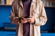 © OchreOchre/Stocksy - Casual Man in Beige Jacket Using Smartphone