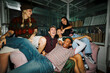 © BONNINSTUDIO/Stocksy - Diverse friends enjoying house party laughing together indoors
