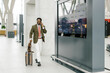 © Mihajlo Ckovric/Stocksy - Businessman Walking Through a Modern Airport Terminal With Luggage