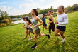 © Javier Díez/Stocksy - Women running together in a park during a sunny afternoon