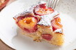 © Anna Fedorova/Stocksy - Slice of Plum Cake With Frangipane and Powdered Sugar Topping