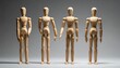 © Artosphere - Four wooden artist mannequins posed in varied expressive stances, arranged on a neutral surface for gesture study.