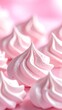 © Slolo - Macro close-up of swirling pink meringue kisses with delicate sprinkles.