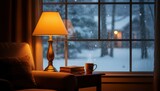 A cozy indoor scene with a warm lamp, book, and mug by a window looking out at a snowy winter landscape with falling snow.