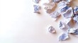 © Lutfi - A top-down view of crumpled paper scattered across a white surface, suggesting ideas, failure, or waste.