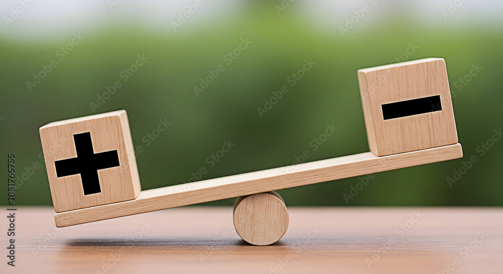 Wooden balance scale with plus and minus signs representing pros and ...