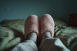 © sam richter - Cozy pink slippers rest comfortably on bed creating peaceful domestic relaxation scene.