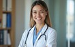 © Elizabeth - Smiling doctor standing in her office. High quality