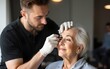 © Jonathan - Male beautician plucking senior lady's eyebrows. High quality