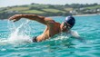 © David - Athletic man swimmer in a blue cap and goggles powerfully swims the front crawl stroke in turquoise open water, creating a dynamic splash under bright sunlight with a blurred coast behind