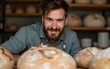 © Matthew - Close up of young man on artisanal sourdough bread production on small bakery. New normal covid-19 economic recovery profession change storytelling concept. High quality