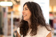 © FotoAndalucia - Happy smiling woman in shopping mall portrait, side view smiling