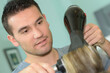 © auremar - closeup of male hairstylist using a blowdryer