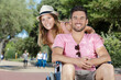 © auremar - young couple in wheelchair strolling in the park