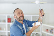 © auremar - man painting ceiling in a new house
