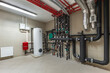 © Alhim - Utility room features a variety of pipes, a water heater, and fittings for managing water flow and heating. The organized setup demonstrates efficient plumbing design and maintenance.