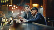 © stockbusters - Bar clients smoking cigarettes in lounge closeup. Drunk men exchanging words