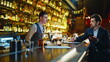 © stockbusters - Waiter working bar counter.Businessman coming cafe ordering drink in evening