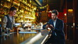 © stockbusters - Wealthy gentleman relaxing bar counter lounge chatting smartphone warm lights