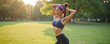 © miss irine - Fit asian woman stretches arms upwards wearing sportswear in park. She prepares for morning workout outdoors. Female athlete enjoys healthy lifestyle and active recreation.