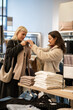 © Zoran Jesic - Women shopping for clothes in a retail store