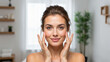 © NeuroCake - Young woman touching her face with healthy skin. Beauty and skincare concept in bathroom