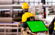 © DC Studio - Industrial manager carrying tablet with green screen during factory evaluation. Professional engineer evaluating system performance using a device with an isolated mockup template.