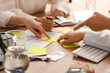 © Pixel-Shot - Business team with many sticky notes during meeting in office, closeup