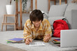 © Pixel-Shot - Male student studying online at home