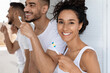 © Prostock-studio - Three friends stand side by side in a sunny bathroom, smiling and brushing their teeth. They share a moment of joy while focusing on oral care together.