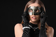 © Pixel-Shot - Beautiful young woman wearing carnival mask on dark background