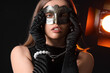 © Pixel-Shot - Beautiful young woman wearing carnival mask on dark background