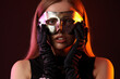 © Pixel-Shot - Beautiful young woman wearing carnival mask on dark background