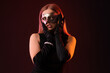 © Pixel-Shot - Beautiful young woman wearing carnival mask on dark background