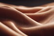 © MKS - Elegant soft waves and folds are formed by brown satin fabric as it drapes under the warmth of light