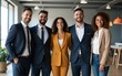 © ning - Happy diverse business team standing in the office. Five cheerful confident successful people in smart casual suits smiling and posing for a group photo all together. Banner. Work and success concept