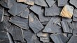 © Daryna - Natural shale surface texture with layered stone fragments creating seamless background pattern in dark charcoal and slate gray tones for web design