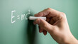 © Lexi - Hand writing E=mc² on chalkboard for Knowledge Day