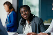 © Suteren Studio - Black Female Manager Providing Feedback to Junior Employee in Multicultural Office